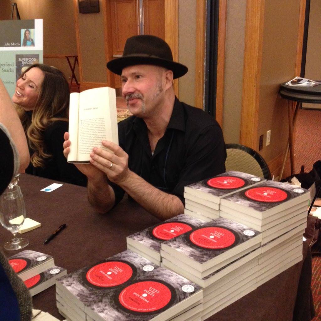 Ray Robertson signing advanced copies of his forthcoming music book Lives of the Poets (with Guitars). Photo by Laura Meyer, House of Anansi's Director of Marketing and Publicity.